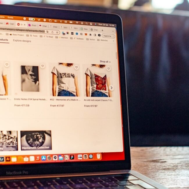 a laptop computer sitting on top of a wooden table